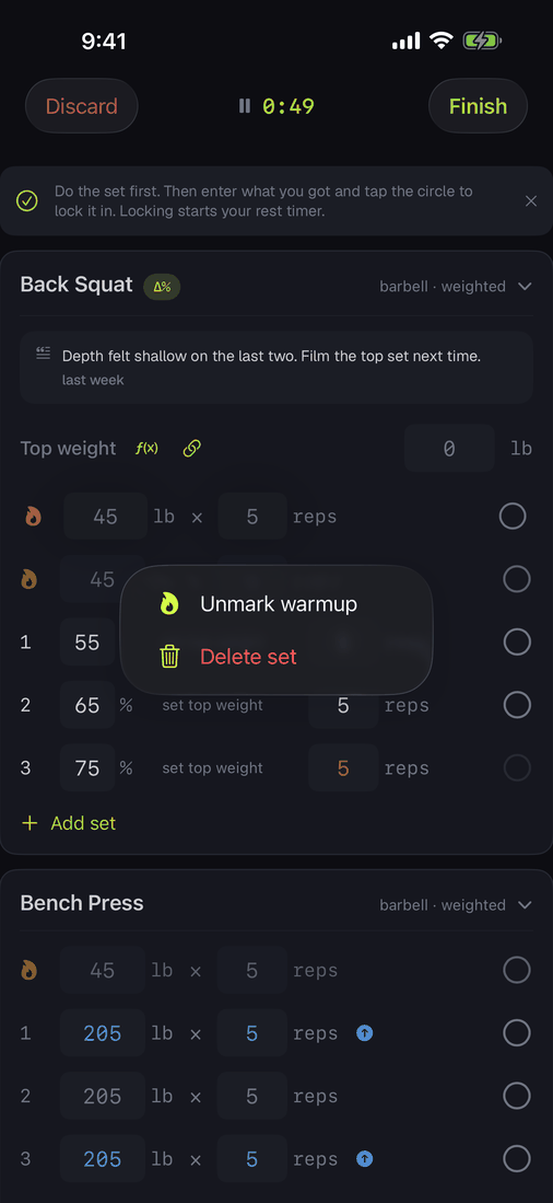 The long-press menu on a set row showing Mark warmup and Delete set.